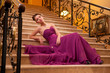 woman in a long dress lying on the stairs