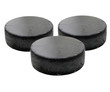 Three old black hockey puck.