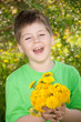 Laughing boy with a bouquet of dandelions Laughing boy with a bouquet of dandelions