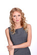 Blond businesswoman wih dress standing on white background