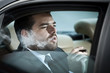 Photo: Man in the back seat of a car smoking Man in the back seat of a car smoking