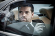 Photo: Man in the back seat of a car Man in the back seat of a car