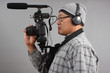 Man with HD SLR camera and audio equipment
