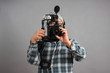 Man with HD SLR camera and audio equipment