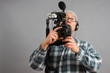 Man with HD SLR camera and audio equipment