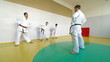 Martial arts instructor training  students in gym