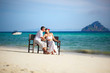 Rear view of loving couple holding hands while relaxing on deck Rear view of loving couple holding hands while relaxing on deck