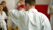 Martial arts instructor training children in gym