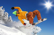 Snowboarder jumping against blue sky