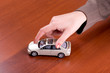 Woman's hand holding the model of car Woman's hand holding the model of car