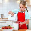 little girl with mixer in kitchen
