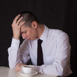upset businessman drinking coffee upset businessman drinking coffee