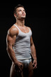 Photo: Muscular sexy wet naked young man posing in a vest Muscular sexy wet naked young man posing in a vest