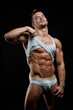 Muscular young sexy wet naked boy takes off his shirt