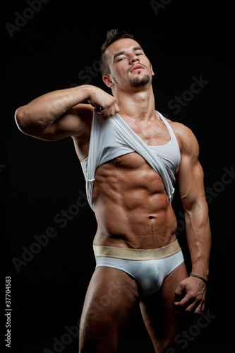 Photo: Muscular young sexy wet naked boy takes off his shirt Muscular young sexy wet naked boy takes off his shirt