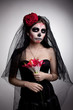 Photo: Serious woman in skull face art mask and flowers Serious woman in skull face art mask and flowers