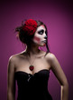 Photo: Young woman in day of the dead mask skull face art Young woman in day of the dead mask skull face art