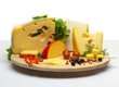 Photo: Cheese still life on a wooden round tray Cheese still life on a wooden round tray