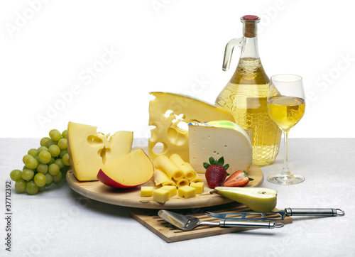 Photo: Cheese still life on a wooden round tray Cheese still life on a wooden round tray