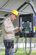 Photo: Technicians Working Under Solar Panels Technicians Working Under Solar Panels