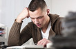Businessman reading documents at office