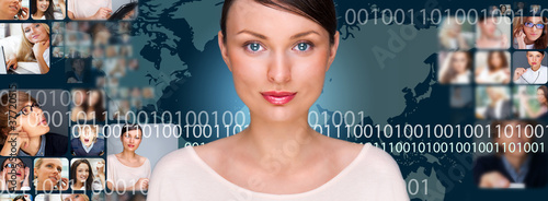 Photo: A young pretty woman against world map on background with many d A young pretty woman against world map on background with many d