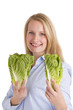 Smiling Blonde Woman Presenting Two Salad Lettuces