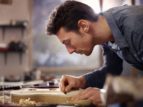 Photo: italian artisan working in lutemaker workshop italian artisan working in lutemaker workshop