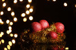 red christmas balls on background of light on black