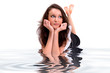 Photo: Young beautiful brunette in dreaming pose with water reflection Young beautiful brunette in dreaming pose with water reflection