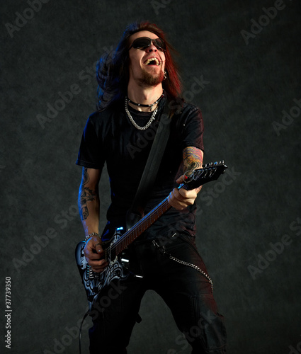 Photo: Brutal man playing electric guitar Brutal man playing electric guitar
