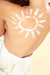 woman with sun-shaped sun cream