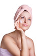 Beautiful woman applying cream