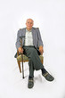 elderly man sitting in his armchaior with walking stick elderly man sitting in his armchaior with walking stick