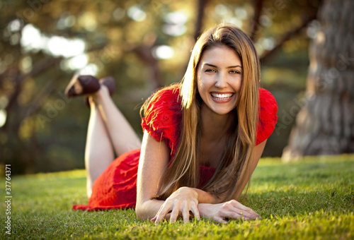 Photo: Beautiful young woman perfect teeth and skin in nature Beautiful young woman perfect teeth and skin in nature