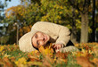 Attractive young woman against autumn leaves
