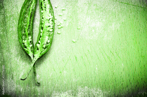 Photo: Peppers background in grunge green style Peppers background in grunge green style