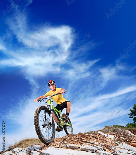 Photo: Person riding a mountiain bike Person riding a mountiain bike