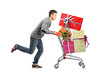 Young man running and pushing a shopping cart with gifts