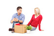 Young man with his wife sitting and resting after moving in