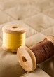 Thread bobbins on a beige fabric