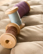 Thread bobbins on a beige fabric