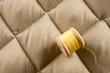 Thread bobbins on a beige fabric