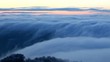 Snowy hills. Dramatic clouds form in a valley
