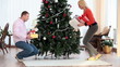 Putting gifts under fir-tree