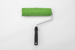 Foto: Green paint roller on white background Green paint roller on white background