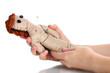 Voodoo doll girl in the hands of women isolated on white