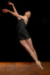 Beautiful Ballerina Leaping in Studio on Black Background