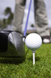 Close up of golf ball on tee and driver set up Close up of golf ball on tee and driver set up