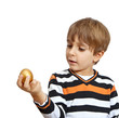 boy holding a golden egg, isolated on white background boy holding a golden egg, isolated on white background